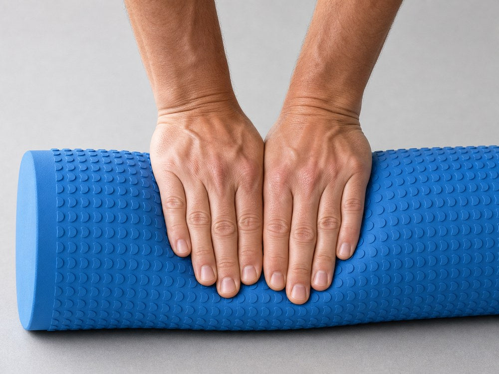 Hands pressing into the AlignaFit foam roller, showing how little the foam compresses