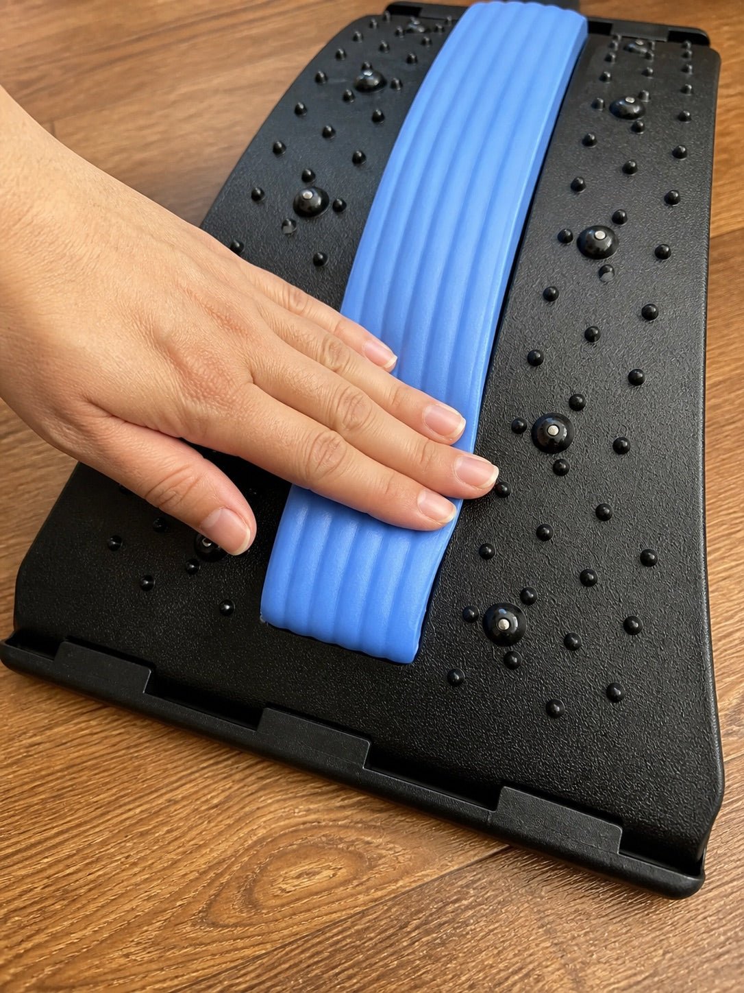 Close-up of the AlignaFit back stretcher foam pad and acupressure surface