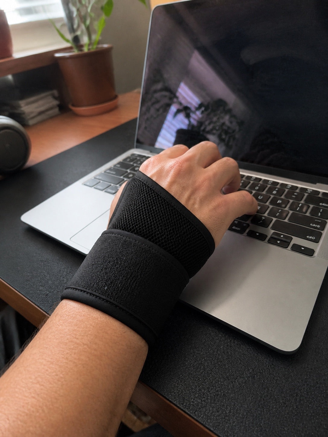 Wearing the AlignaFit wrist brace while typing at a desk