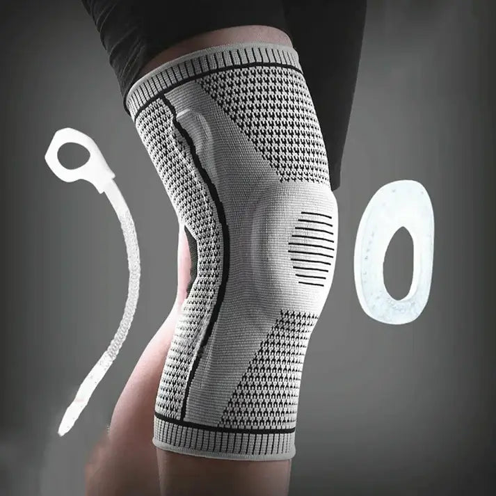 Knee brace being worn on a person's knee with a gray background