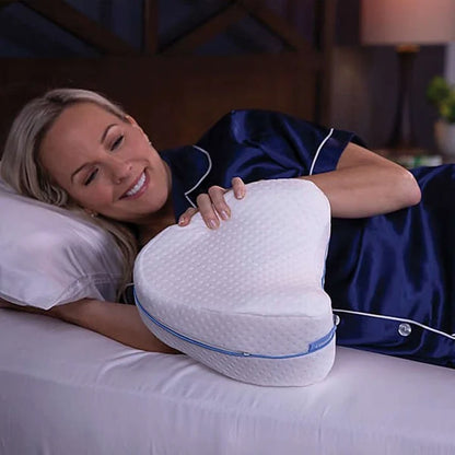 Woman in bed, about to use the orthopedic knee pillow