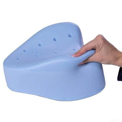 Blue foam from the orthopedic knee pillow held by a hand on a white background