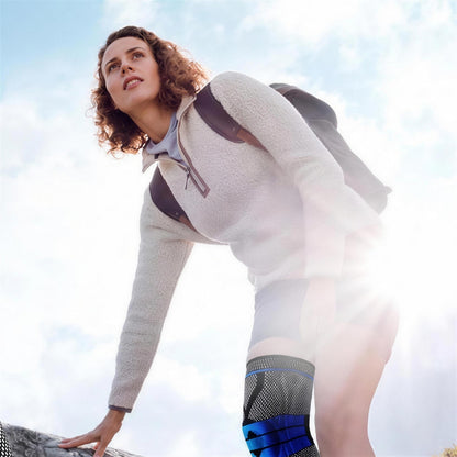 Woman hiking outdoors wearing the black AlignaFit knee compression sleeve