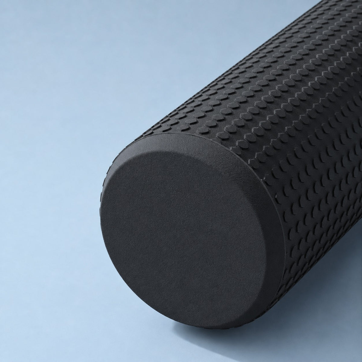 Close-up of the black AlignaFit foam roller's trigger point texture