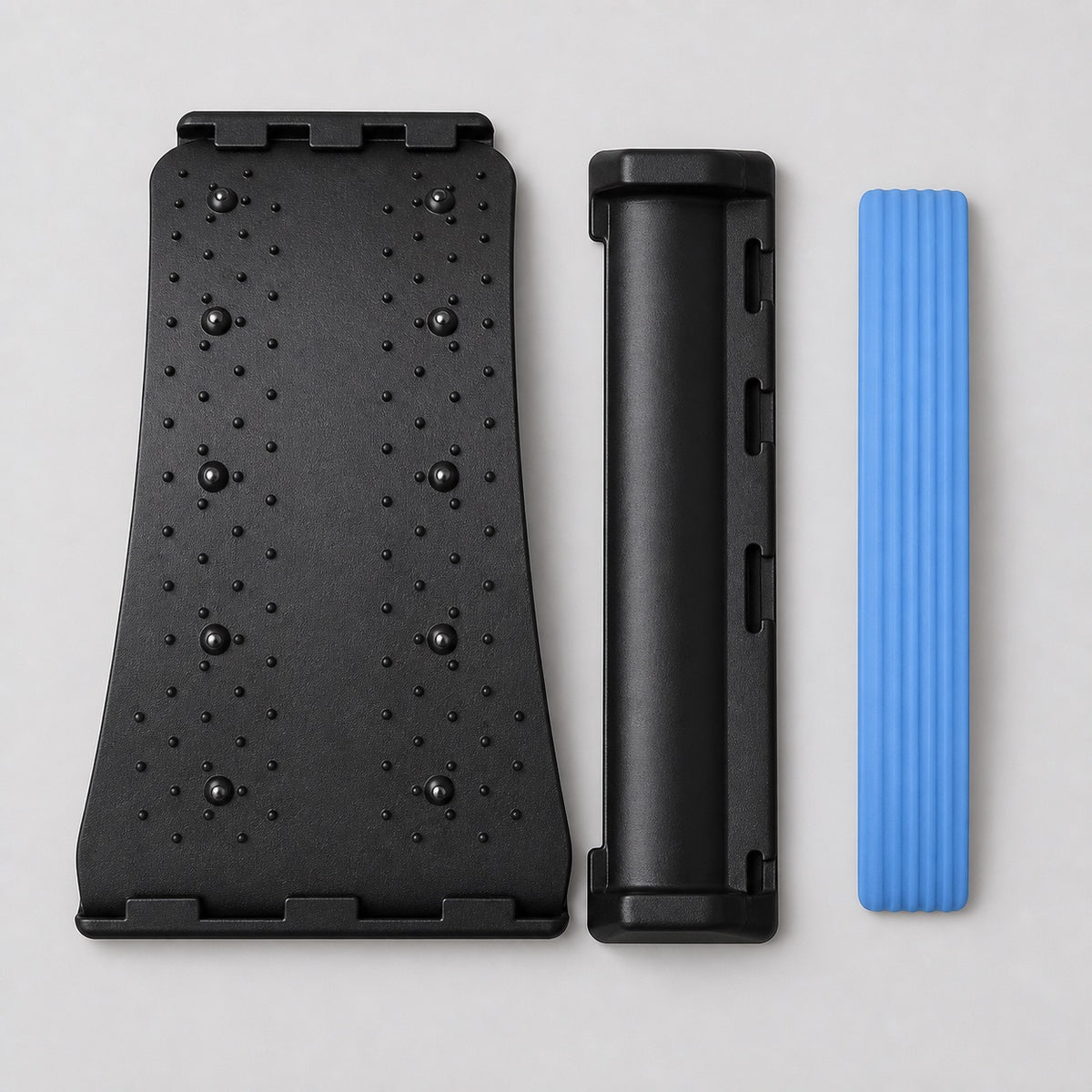 AlignaFit back stretcher components laid flat: massage board, base and blue foam lumbar pad