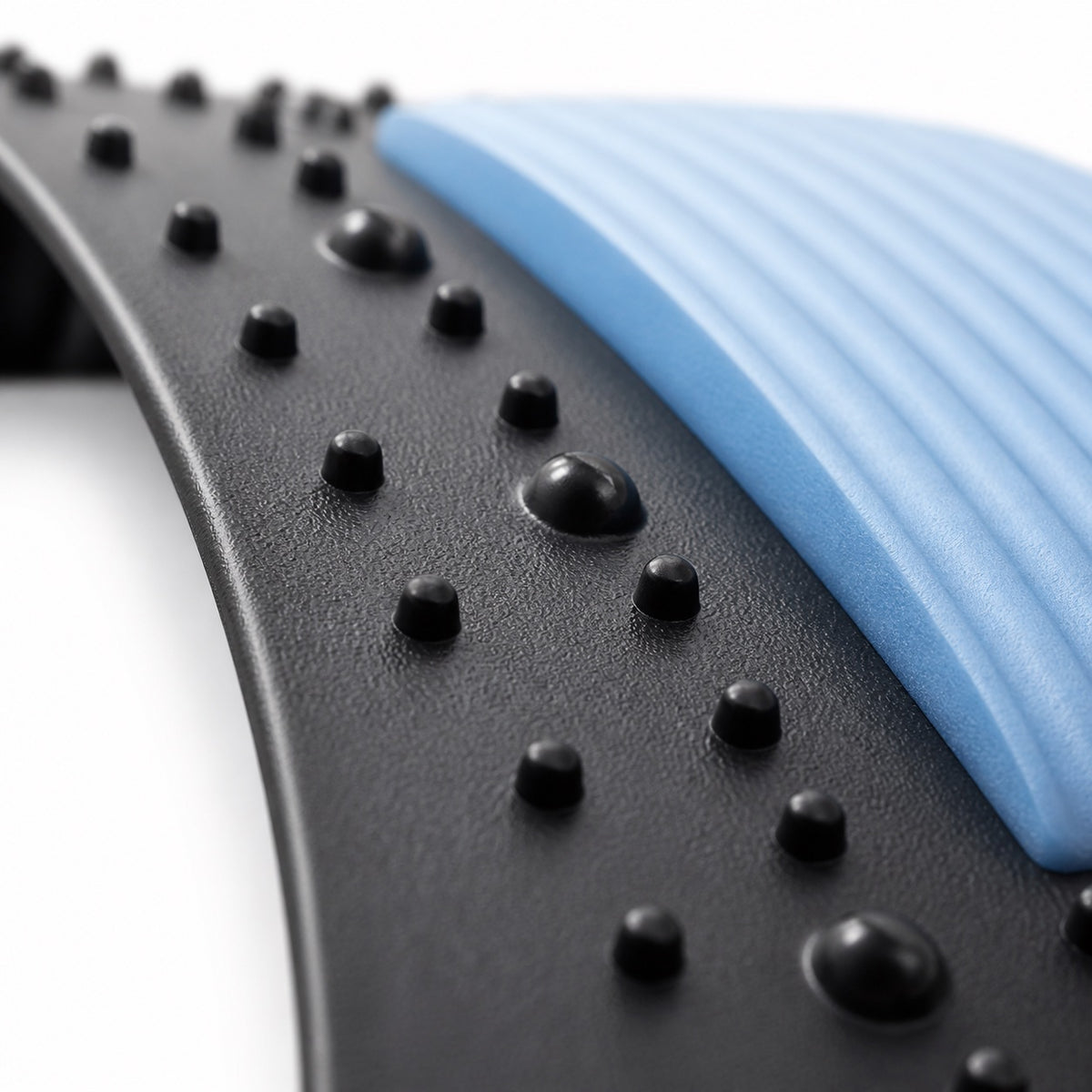 Close-up of the AlignaFit back stretcher acupressure nubs and ribbed blue foam pad