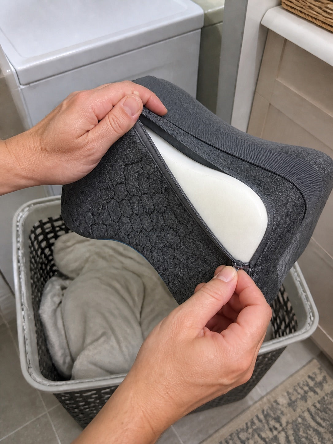 Unzipping the washable cover of the AlignaFit knee pillow
