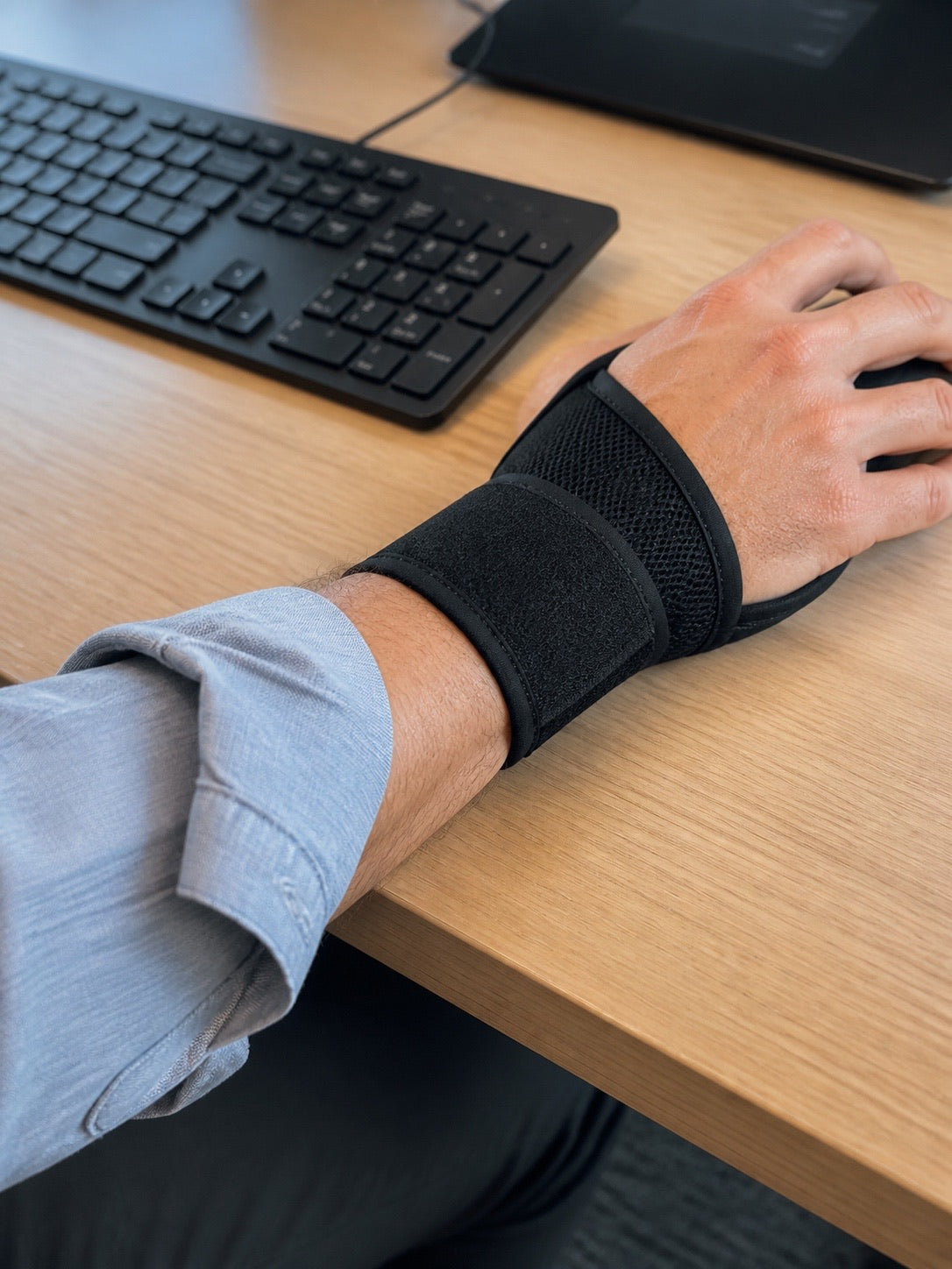 The AlignaFit wrist brace worn under a shirt cuff